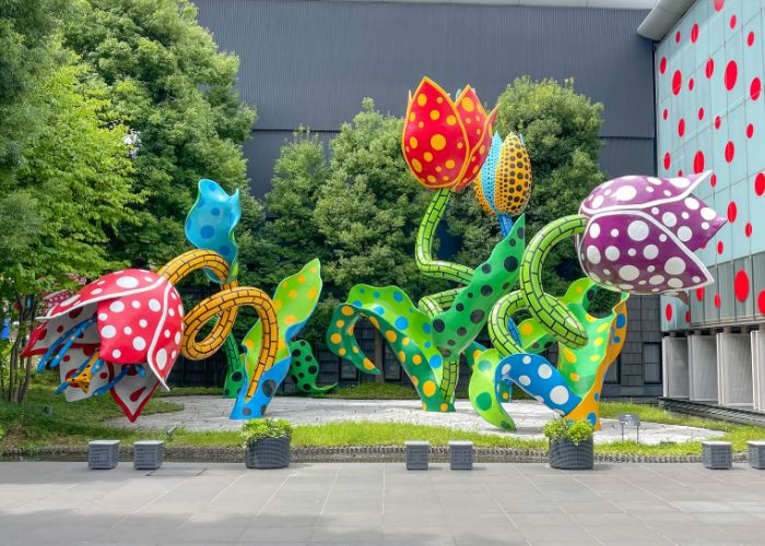 A vividly colored statue of flowers sculpted by Yayoi Kusama is displayed outside the Matsumoto City Museum of Art